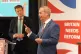 Nigel Farage speaks as Leader of Reform UK Richard Tice look