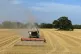 A farmer harvesting the last of his wheat crop on his farm, 