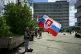 A man prays holding Slovakia's flag outside the F. D. Roosev