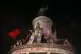 People climb on the statue at Republique plaza during a prot