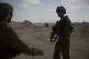 Israeli soldiers take up positions next to the Philadelphi C