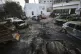 Men look over the site of a deadly explosion at Al-Ahli Hosp