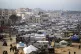 A tent camp for displaced Palestinians is set up amid destro