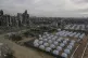 A tent camp for displaced Palestinians is set up amid destro