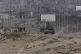 A Palestinian runs away from an Israeli tank in the central 