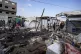 Palestinians inspect the damage at a tent area in the courty