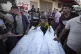 Mourners gather around bodies of Palestinians killed in the 