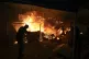 Palestinians react to a fire after an Israeli strike hit a t