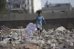 A Palestinian kid sorts through trash at a landfill in Zawai