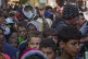 Palestinian children queue for donated food in Deir al-Balah