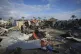 Palestinians survey the aftermath of an Israeli army airstri