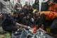 Palestinians mourn over the bodies of civil defence workers 