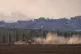 Israeli soldiers move on armored personnel carriers (APC) ne