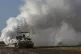 An Israeli army tank moves near the Gaza Strip border, in so
