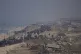 Displaced Palestinians walk on a road in central Gaza to ret