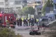 Israeli police officers and firefighters work at the site of
