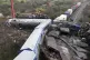 A crane, firefighters and rescuers operate after a collision