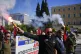 Protesters hold flares as they take part in rally, during a 