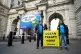 Four Greenpeace activists unfurl a banner saying 