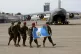 U.N backed Guatemala police force walk on the tarmac of the 
