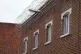 Barbed wire and windows to cells on the walls of HMP Bedford