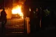 A police car burns as officers are deployed on the streets o