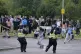 A youth throws a fence post towards police during an anti-im