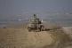 Israeli Defense Forces soldiers work on their tank near the 