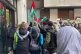 Palestine Solidarity Campaign director Ben Jamal raises his 