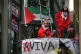 Palestine Action activists atop the entrance to Aviva’s Ma