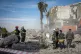 Emergency services clear the rubble of the house of Peshraw 