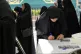 A woman fills out her ballot during the Iranian presidential