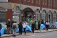 People walking past tents housing asylum seekers near to the