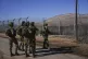 Israeli soldiers patrol the perimeter of the agricultural se