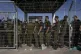 Israeli soldiers gather at the gate to the Sde Teiman milita
