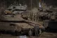 Israeli soldiers work on tanks and armoured personnel carrie