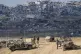 Israeli soldiers take up positions near the Gaza Strip borde
