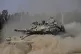 An Israeli tank manoeuvres near the Israel-Gaza border, July