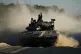 An Israeli soldier waves from a moving tank near the Israeli
