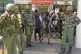 Kenya anti riot police stand guard as stranded passengers wa