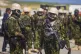 Police from Kenya stand on the tarmac of the Toussaint Louve