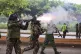 Police officers fire tear gas canisters during a protest ove