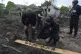 A Ukrainian police officer and war crime prosecutor inspect 