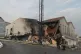 Firefighters extinguish a fire after a rocket hit a building