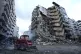 A Civil Defense worker uses a skid loader to remove the rubb