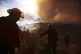 Firefighters work to control the spread of the Hughes Fire i