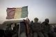 Malian army commandos ride in a convoy on a road outside Gao