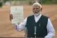 Indian Prime Minister Narendra Modi displays a letter from t
