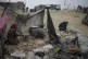 Mona Al-Zebda, displaced from Gaza City, bakes bread at a te
