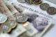Money is stacked on top of a council tax bill
